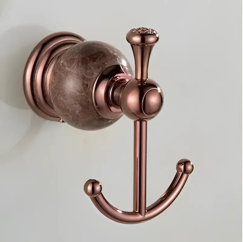 Antique bronze-finished double hook towel rack with textured spherical base in jade rose gold bathroom set