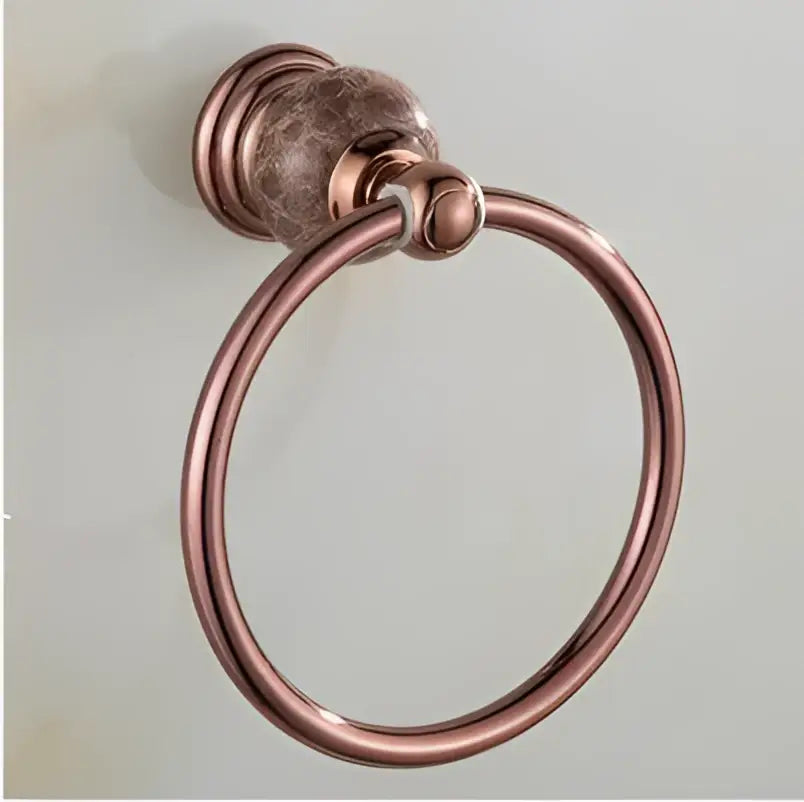 Antique copper-finished towel ring with textured spherical mount and smooth loop in jade rose gold bathroom set