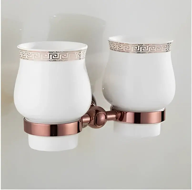 White ceramic toothbrush holders with rose gold greek key pattern and copper mounting brackets from jade rose gold bathroom set