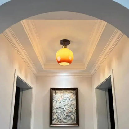 Japanese amber glass led ceiling lamp with warm gradient globe and brass-finished base for living room decorbites led ceiling