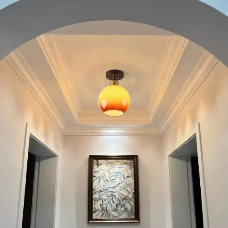 Japanese amber glass led ceiling lamp with warm gradient globe and brass-finished base for living room decorbites led ceiling