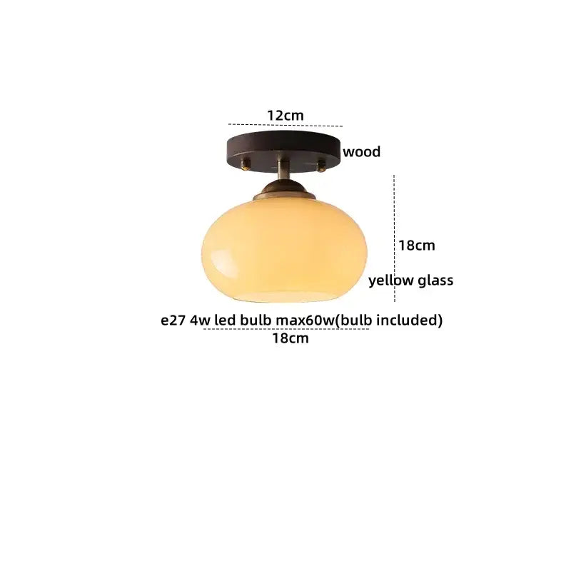 A warm yellow japanese amber glass led ceiling lamp with brass and dark wood mount for elegant living room decorbites led ceiling lighting