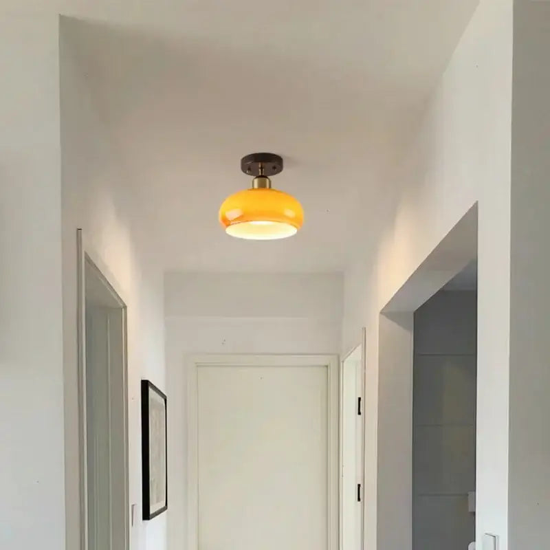 A warm yellow glass ceiling lamp with brass finish by decorbites led ceiling for living room decor