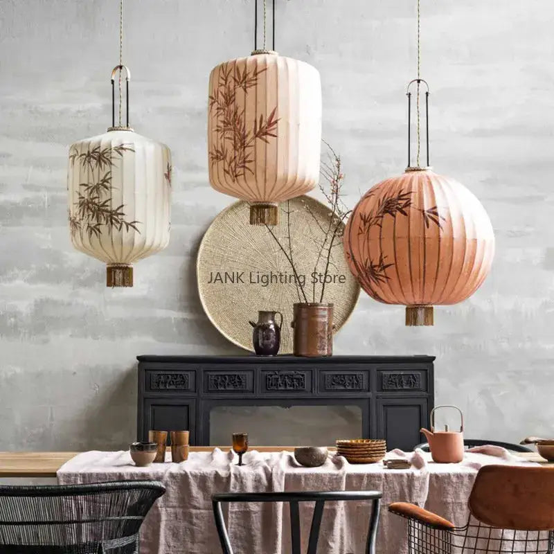 Three hanging paper lanterns with bamboo leaf pattern in cream peach and terracotta for living room pendant light
