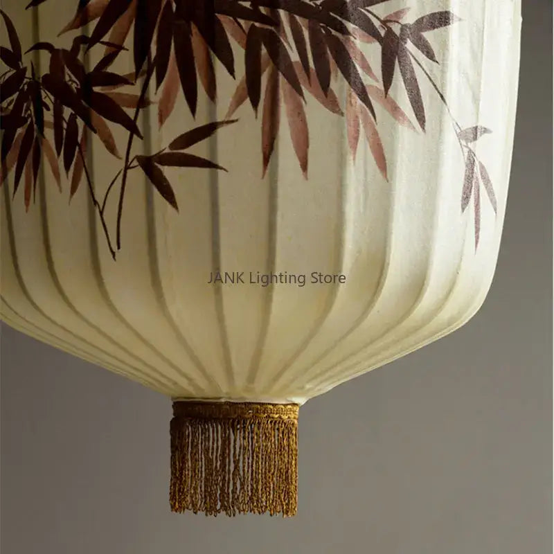 Cream-colored Japanese paper lantern with delicate brown bamboo leaf pattern and golden tassel for living room pendant light