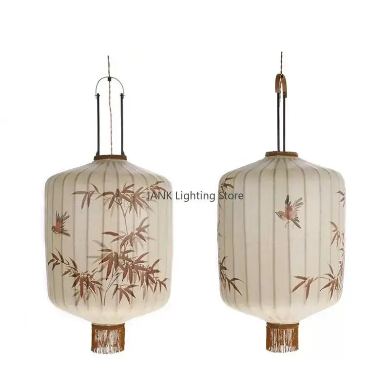 Cream-colored Japanese bamboo leaf pattern paper lantern with brown bird illustrations and woven fringe pendant light