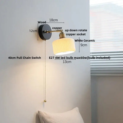 Japanese black wood wall light with copper arm and white ceramic shade featuring a pull chain switch for bedroom use