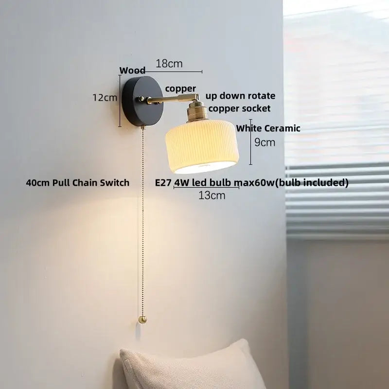 Japanese black wood wall light with copper arm and white ceramic shade featuring a pull chain switch for bedroom use