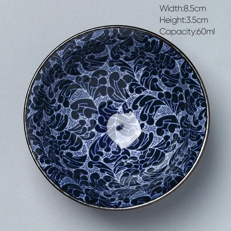 A blue and white decorbites ceramic kung fu tea porcelain bowl with floral pattern glossy finish and metallic rim