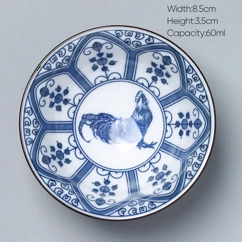 A white ceramic kung fu tea cup with blue rooster design floral patterns and gold-rimmed edge by decorbites ceramic kung