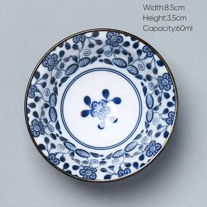 A delicate white porcelain saucer with blue floral patterns and gold rim from decorbites ceramic kung fu tea set