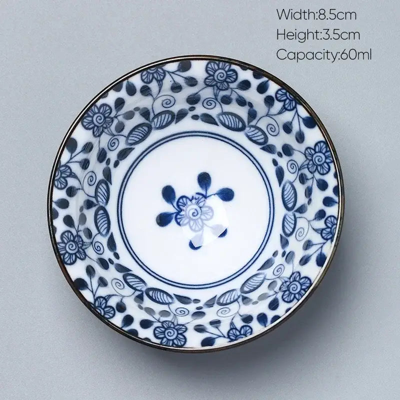 A delicate white porcelain saucer with blue floral patterns and gold rim from decorbites ceramic kung fu tea set