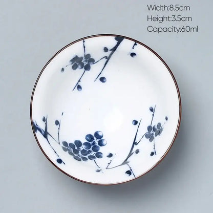 A white porcelain decorbites ceramic kung fu tea bowl with blue plum blossom patterns and a thin brown rim
