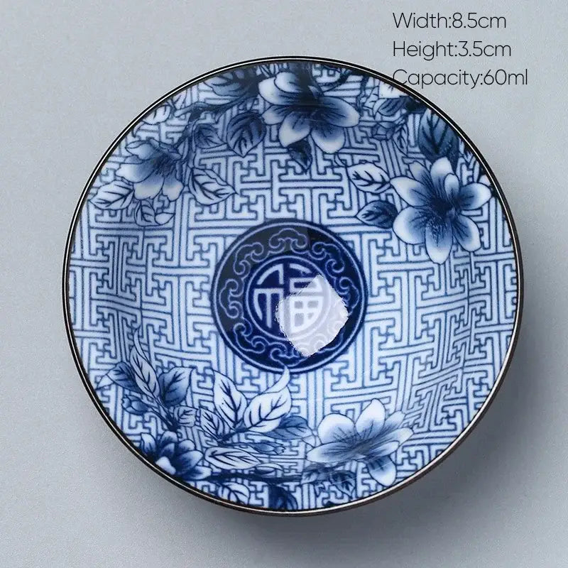 Japanese blue and white kung fu tea porcelain bowl with intricate floral patterns, chinese characters, and metallic rim decorbites ceramic kung