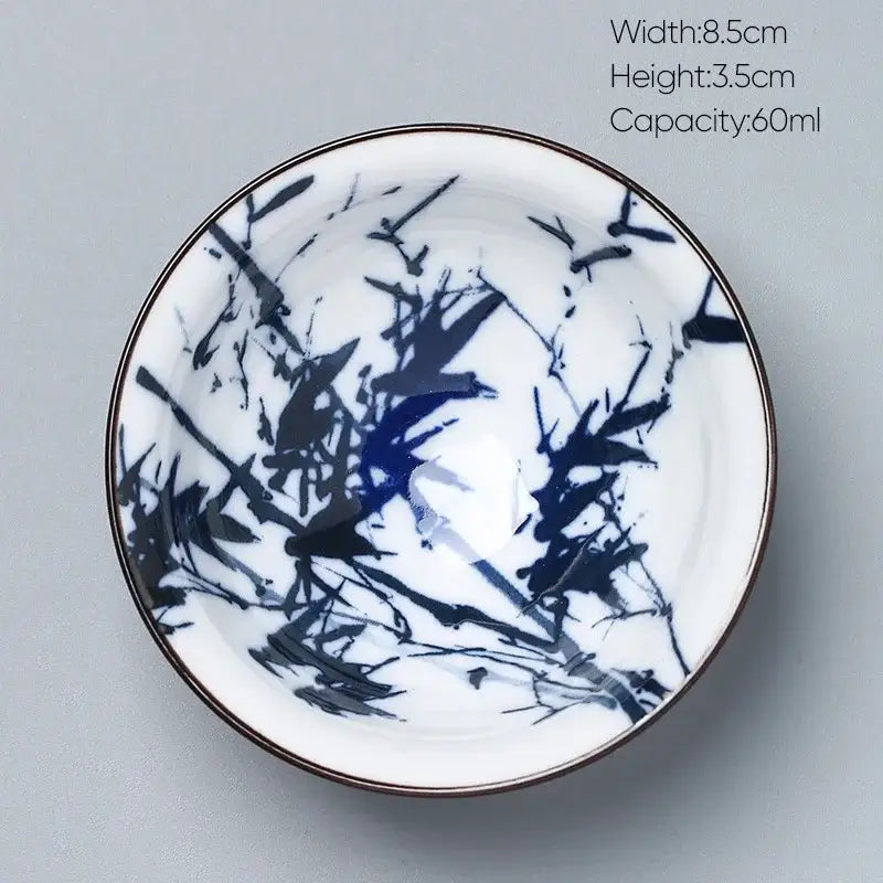A decorbites ceramic kung fu tea cup porcelain bowl in white with blue black bamboo design and thin metallic rim
