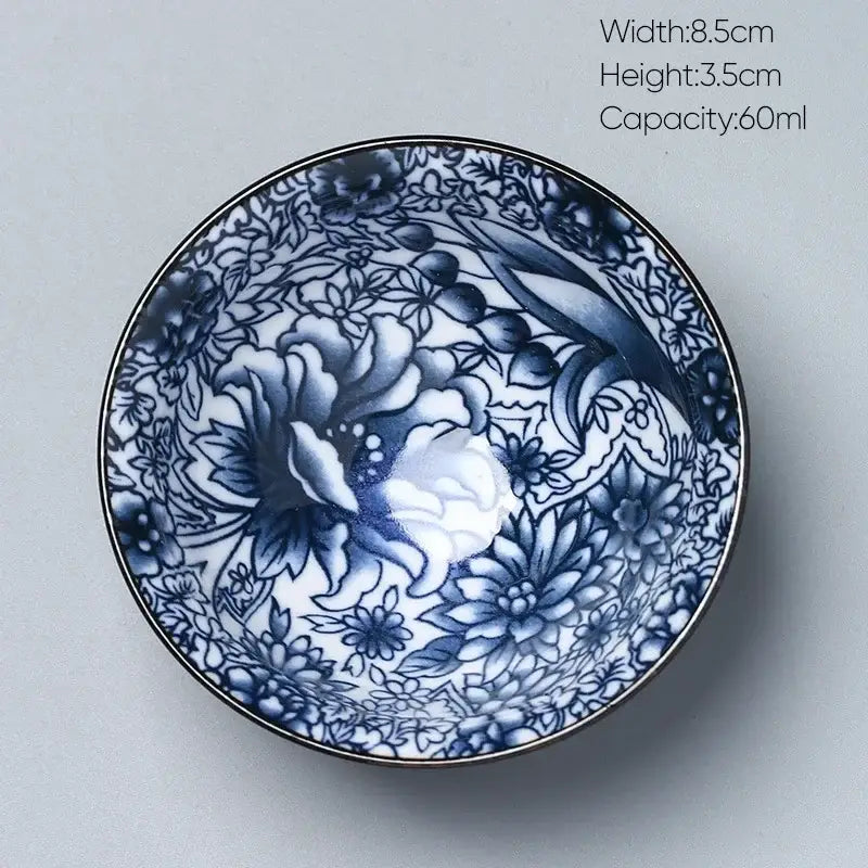 A delicate blue and white porcelain kung fu tea cup with intricate floral design by decorbites ceramic