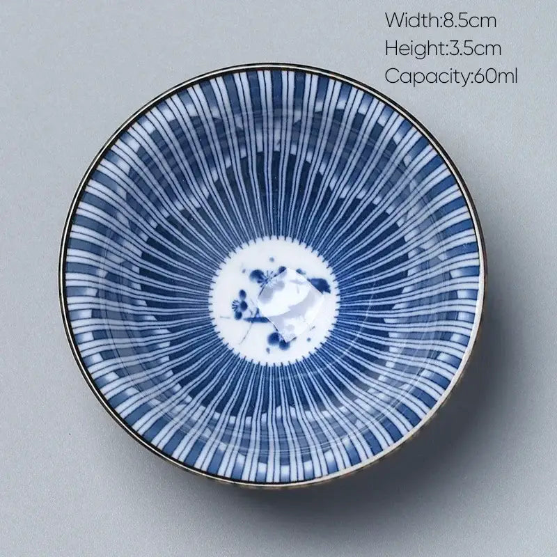 A delicate blue and white ceramic kung fu tea cup porcelain bowl with gold rim and floral motif by decorbites ceramic kung