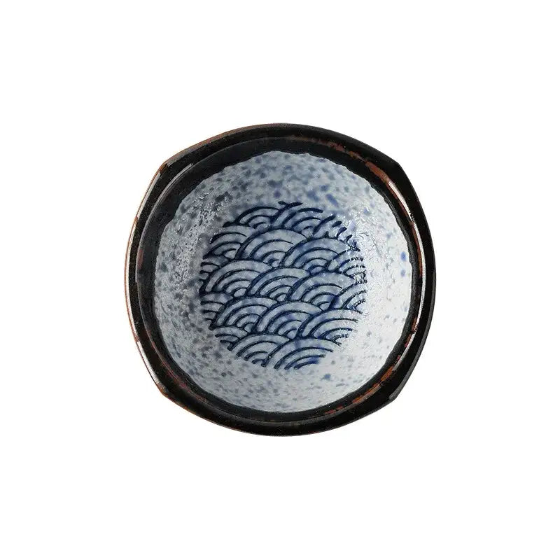 A ceramic japanese porcelain sake bowl with blue wave patterns and a dark glossy rim for decorbites ceramic japanese set