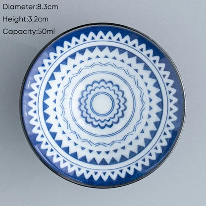 A blue and white ceramic kung fu tea cup with a geometric concentric pattern for dining room use