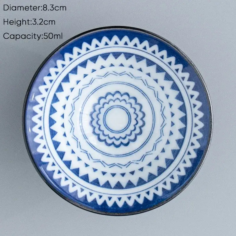 A blue and white ceramic kung fu tea cup with a geometric concentric pattern for dining room use