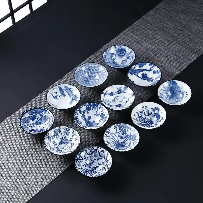 Set of ten blue and white ceramic kung fu tea cups with intricate floral fish bamboo and bird motifs for dining room use