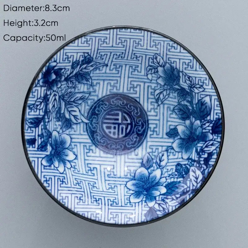 Blue and white ceramic kung fu tea cup with intricate floral patterns and central chinese character design