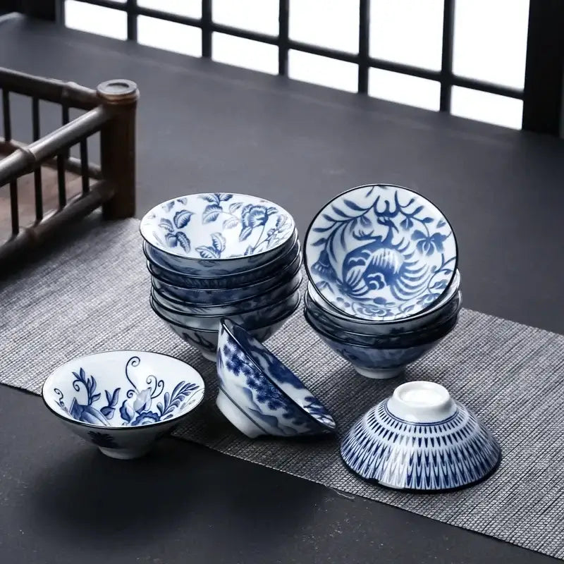 Set of blue and white ceramic kung fu tea cups with intricate floral and bird patterns for tea dining room use