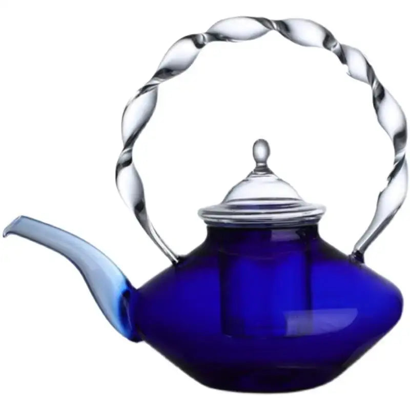 A deep cobalt blue glass teapot with twisted clear glass handle and spout perfect for decorbites blue glass decor