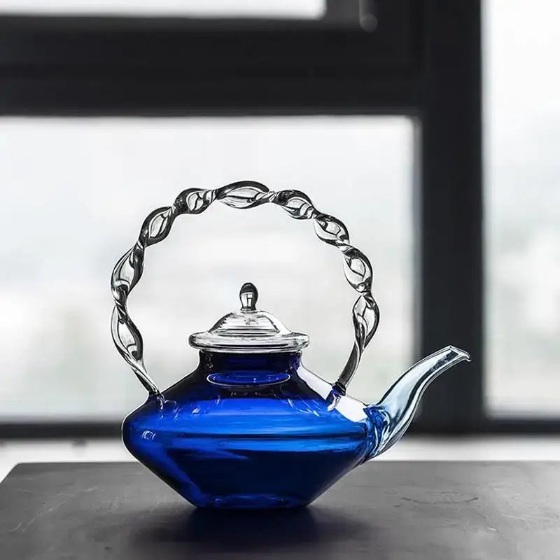 Japanese cobalt blue glass teapot with a twisted clear glass handle and lid for elegant kitchen decorbites blue glass decor