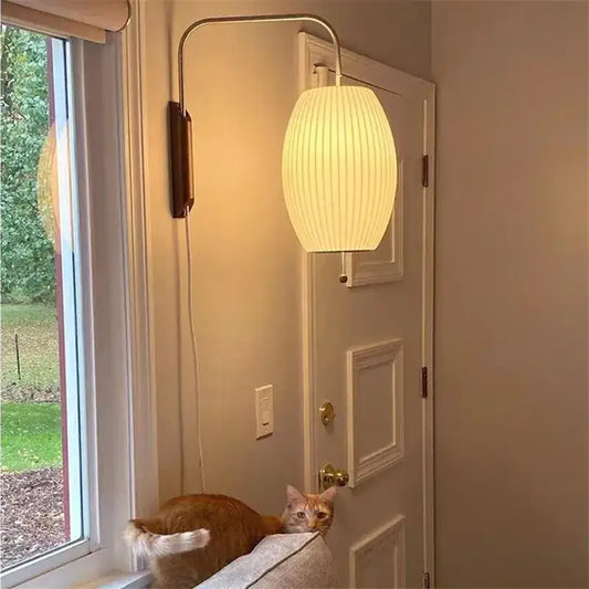 Cream-colored ribbed paper shade wall light with curved metallic arm decorbites handwoven silk ball for bedroom decor