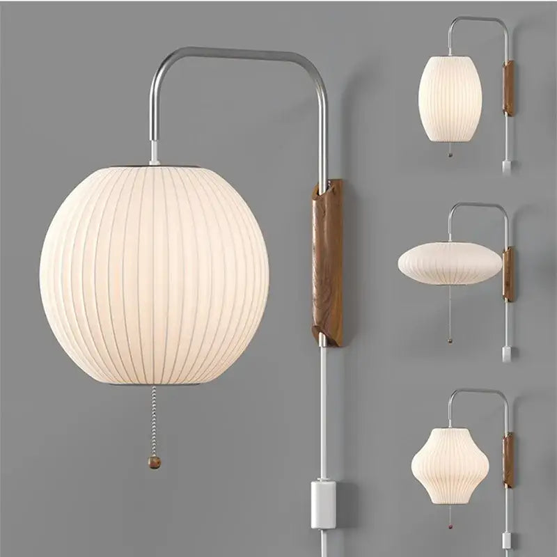 Cream-colored japanese wall light with ribbed paper shade wooden accent and chrome arm decorbites handwoven silk ball