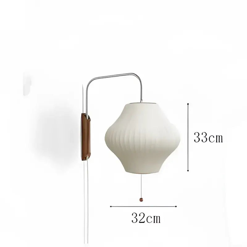 A modern wall light with a curved metallic arm and cream ribbed handwoven silk ball shade by decorbites