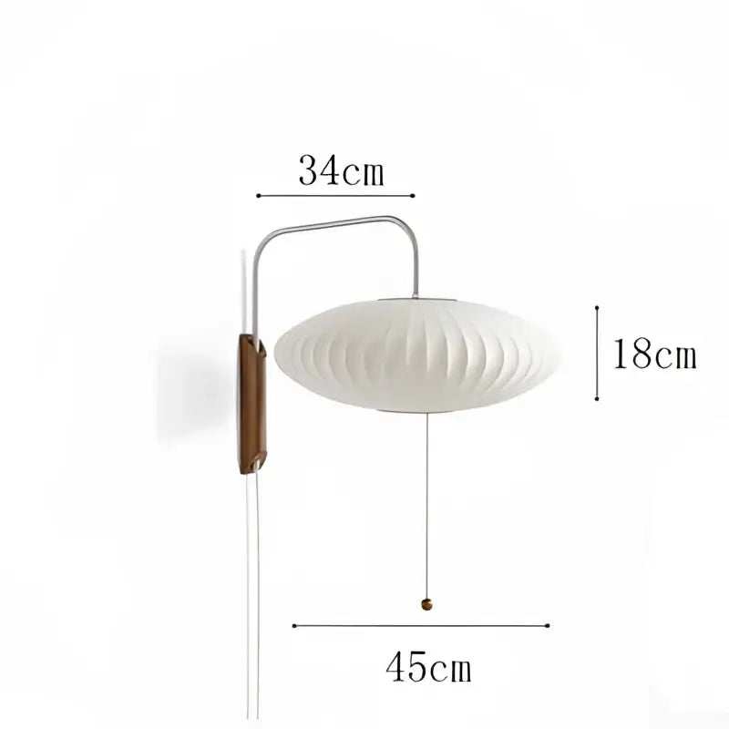 A sleek white wall light with a ribbed handwoven silk ball shade and wooden detail for bedroom decorbites handwoven silk