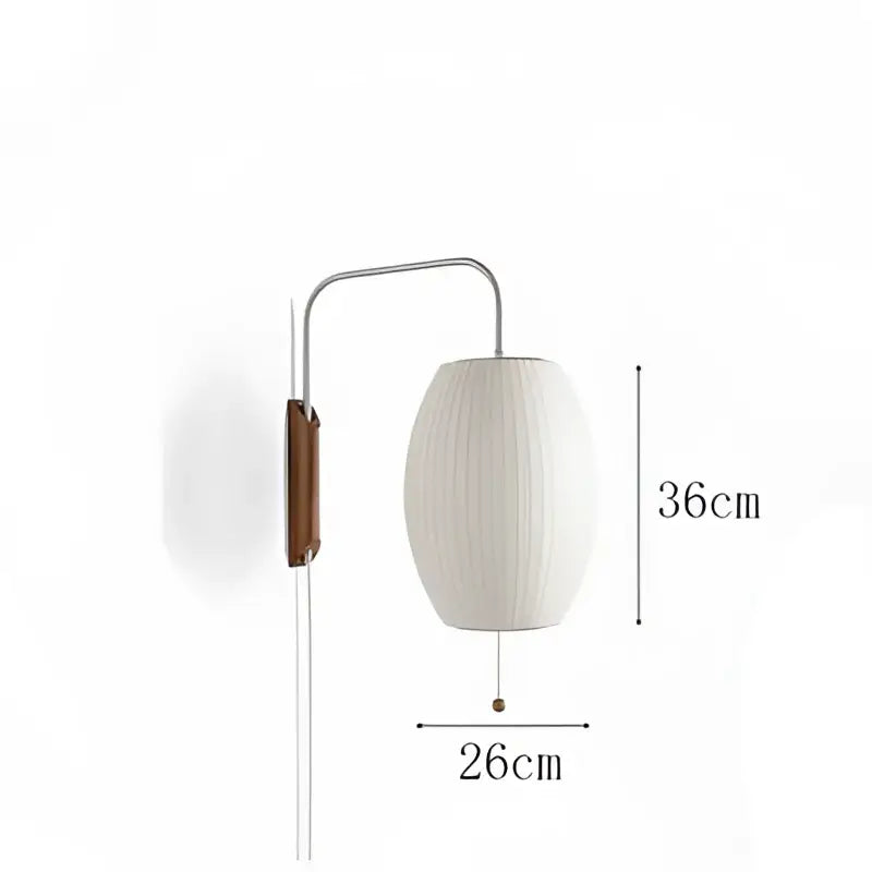 A sleek Japanese cream ribbed handwoven silk ball wall light with a metallic arm and wooden detail for bedroom decorbites