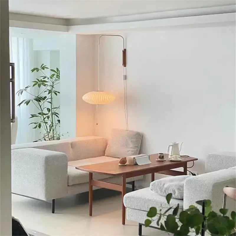 A warm wall light with a ribbed beige handwoven silk ball shade and wooden accents for bedroom decorbites handwoven silk