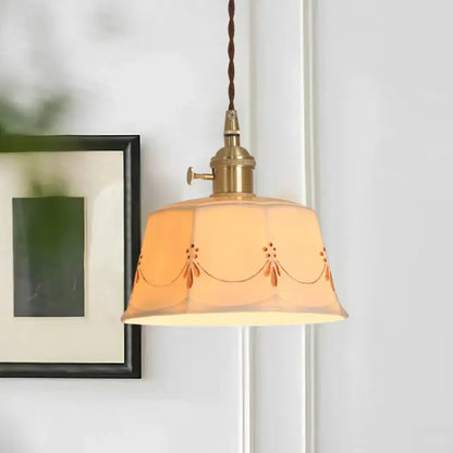 A warm amber ceramic led pendant light with orange floral embroidery and brass fixture for living room decorbites ceramic led
