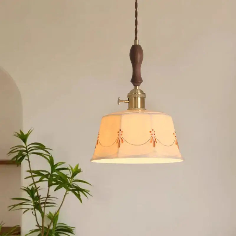 A warm-toned cream ceramic led pendant light with embroidered floral patterns and dark wood handle for living room decorbites ceramic led