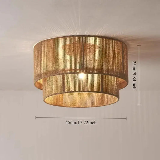 Golden two tiered woven pendant light made of natural materials providing warm light source for dining room