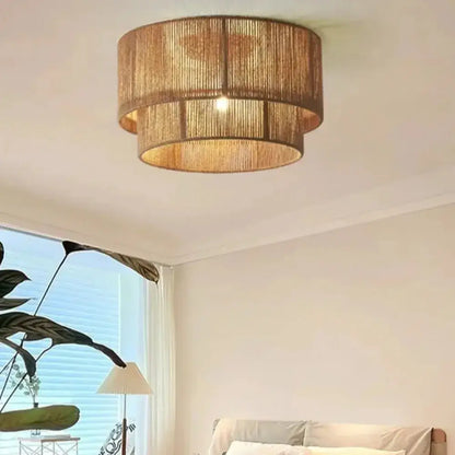 Japanese golden two tiered woven pendant light with natural materials and a warm rattan layered circular light source