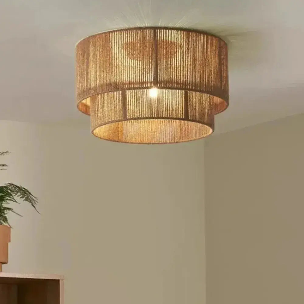 Japanese golden two tiered pendant light made of woven natural materials providing a warm light source for dining room