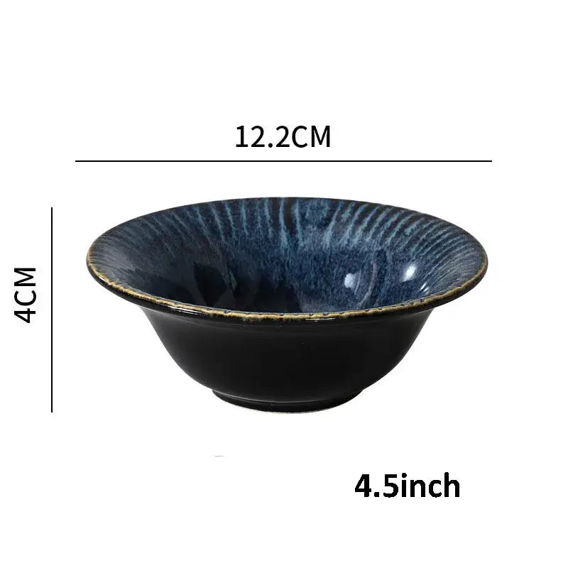 A deep blue ceramic dinnerware bowl with textured glazed interior and rustic gold rim from decorbites ceramic set