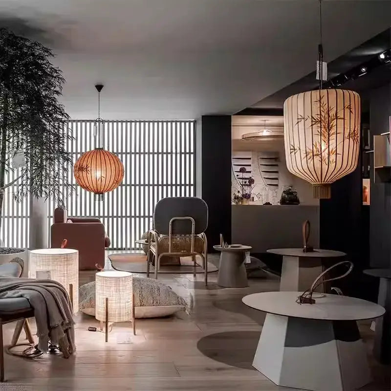 A warm-toned japanese lantern painting on peach fabric with delicate bamboo leaf patterns for dining room light