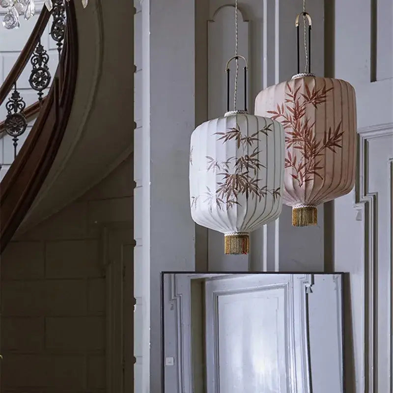 Two elegant japanese lantern paintings in white and blush pink peach fabric with bamboo embroidery and golden tassels for dining room lighting