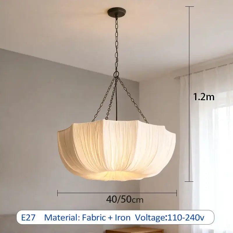 Cream-colored fabric pendant light with black iron chain is a refined choice for hospitality settings