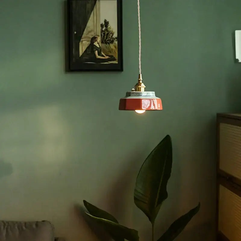 Japanese retro ceramic pendant light with a warm-toned orange-red hexagonal ceramic pendant shade and brass fixture for dining room