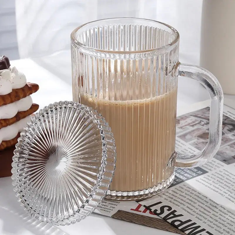 Clear ribbed glass coffee cup set with matching fan-shaped lid filled with coffee by decorbites glass coffee