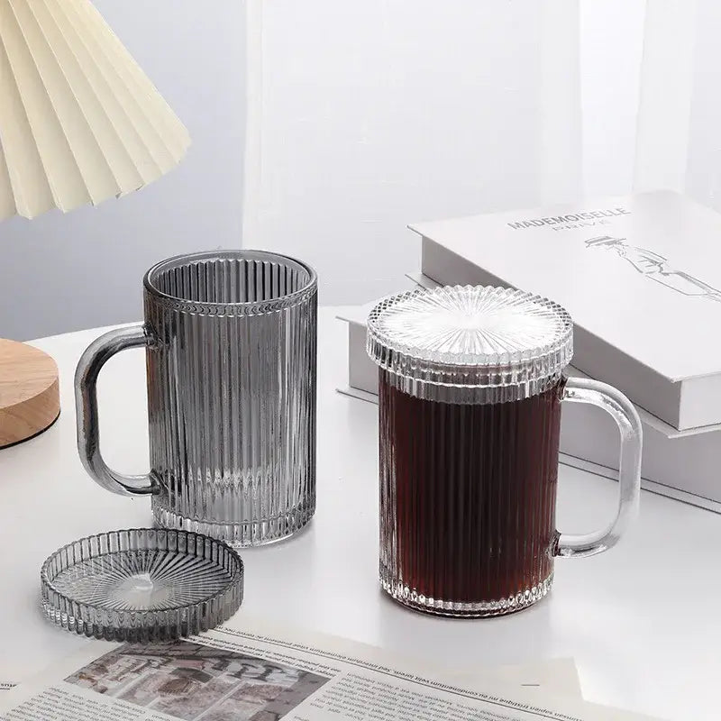 Clear glass coffee cup set with vertical ribbed texture and lids featuring dark liquid for decorbites glass coffee