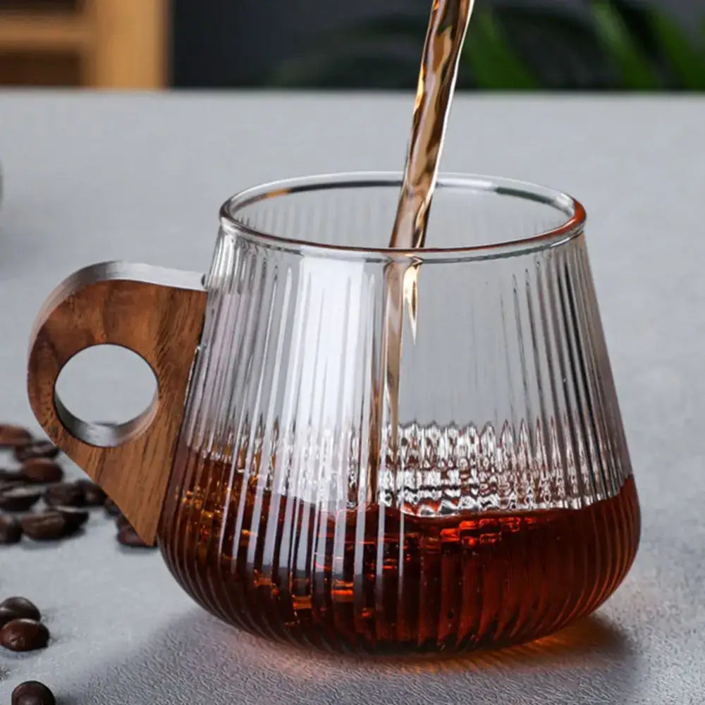 Japanese ribbed glass coffee mug with vertical ridges and wooden handle filled with dark coffee for kitchen use