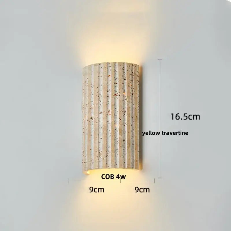 A sleek beige iron led wall light with vertically ribbed natural yellow travertine stone for bedroom decorbites iron led