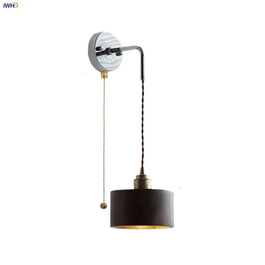 Black cylindrical wall lamp with brass pull chain metal fixture ideal for stair light fixtures in Japanese style